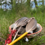 indiginous feather smudge bowl in canadian forest and mountains